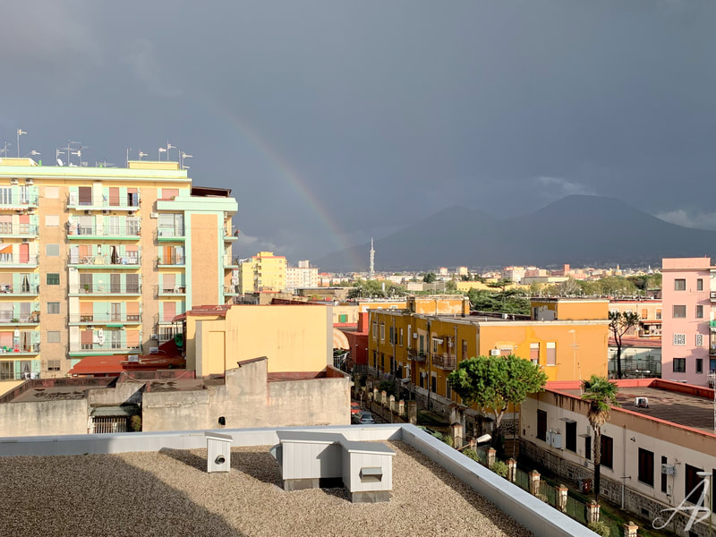 A rainbow touching down in front of Mount Vesuvius, taken from the kitchen window at the Apple Developer Academy in Naples, Italy