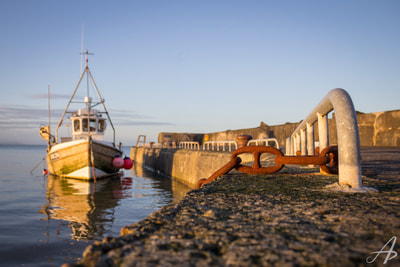 Boat docked at sunset in Cahore, Wexford County, Ireland